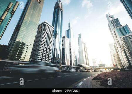 Cars passing on highway in front of skyscrapers Dubai - UAE Stock Photo