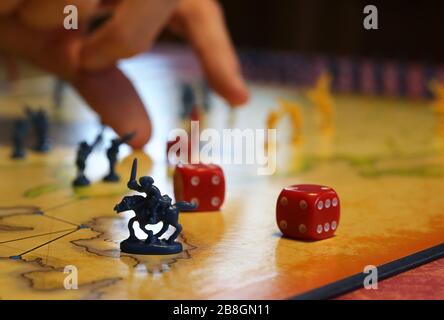 Kaufbeuren, Germany. 21st Mar, 2020. A family plays the board game 'Risk' in their house. (to dpa-KORR: 'Lagerkoller or a chance? How to (survive) in isolation' from 22.03.2020). Credit: Karl-Josef Hildenbrand/dpa/Alamy Live News Stock Photo