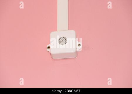 White loudspeaker of the fire system on the pink wall. Fire safety concept. Stock Photo