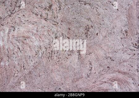 Natural texture of pink granite stone. Background for text and design. Stock Photo