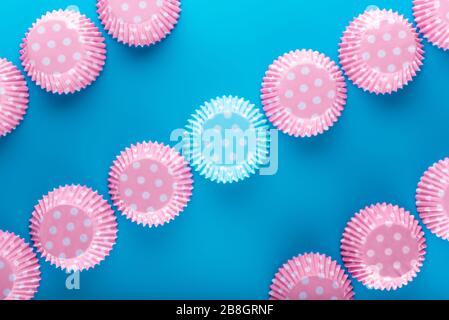 Muffin cases. Cake cases. Top View. Flat laying. Blue background.  Flat View. Straight line from corner to corner. Cupcake case. paper colorful cupcak Stock Photo