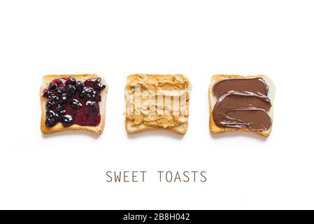 Three toasts,  bread with chocolate spread, peanut butter and jam  isolated on white, top view, banner. Set of sweet sandwiches, unhealthy food. Stock Photo