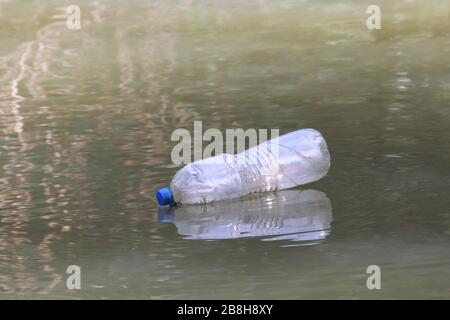 Plastic Bottle Waste On the water surface dirty, Rotten water, Bottle Waste Stock Photo