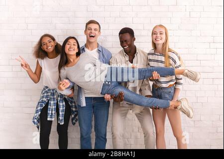 A group of friends pose for a photo while on the couch Stock Photo | Adobe  Stock