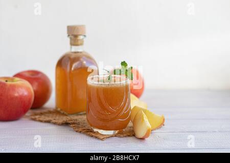 Freshly squeezed apple juice on a white background. Useful vitamin, antiviral drink. Copy space Stock Photo