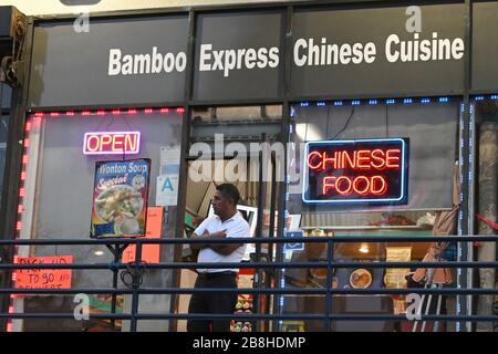 A man stands outside the Bamboo Express Chinese Cuisine restaurant awaiting customers in the wake of the coronavirus COVID-19 pandemic outbreak, Saturday, March 21, 2020, in Los Angeles. (Photo by IOS/Espa-Images) Stock Photo