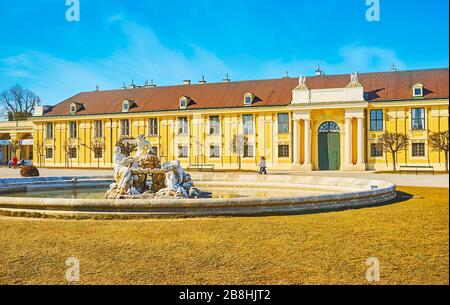 VIENNA, AUSTRIA - FEBRUARY 19, 2019: The sunny courtyard of Schonbrunn palace with a view on Ehrenhof fountain and Imperial Carriage museum building o Stock Photo