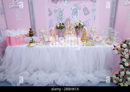 Many delicious yummy sweet cakes and candies on wedding table. Stock Photo