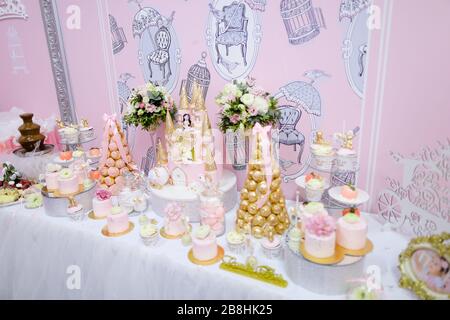 Many sweets, cakes and candies on wedding table. Stock Photo