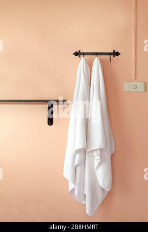 towel, a towel hangs on an orange wall (selective focus) Stock Photo