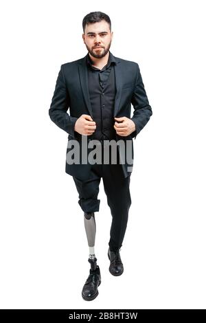 Disabled young man with prosthetic leg, artificial limb concept. Standing in studio isolated over white background Stock Photo