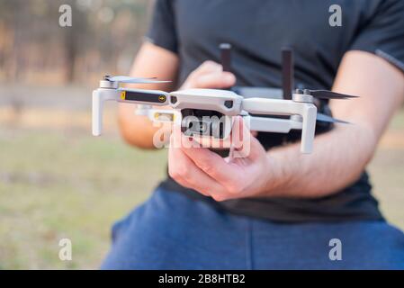 young man controls launches a modern drone for video and photo Stock Photo