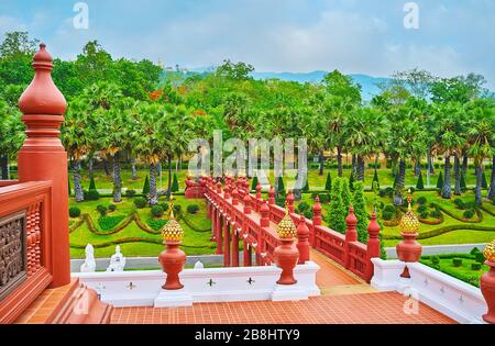 The terrace of Royal pavilion is connected with garden with ochre bridge across the moat, Rajapruek park, Chiang Mai, Thailand Stock Photo