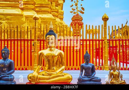 The line of Buddha Images in Touching Earth (Earth the Witness) gesture at the main chedi (stupa) of Wat Phra That Doi Suthep temple, Chiang Mai, Thai Stock Photo