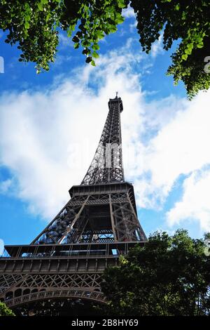 Paris; a view looking up at the Eiffel Tower on a sunny summers day from Allée Thomy-Thierry, Champ de Mars Stock Photo