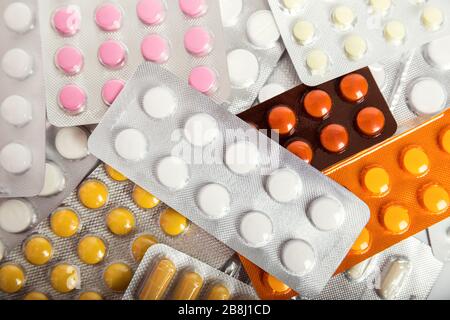 Different pills packed in blisters, medical pharmaceutical background Stock Photo