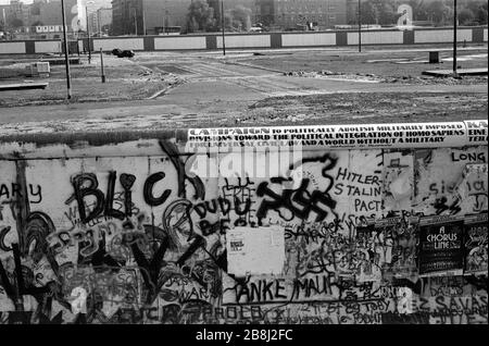 A section of the Berlin Wall at the Brandenburg Gate, West Berlin looking into no-man's land. The Berlin Wall was a barrier constructed by the German Democratic Republic (GDR, East Germany) starting on 13 August 1961, that completely cut off West Berlin from surrounding East Germany and from East Berlin. The Wall was opened on 9. November 1989 allowing free movement of people from east to west. Stock Photo