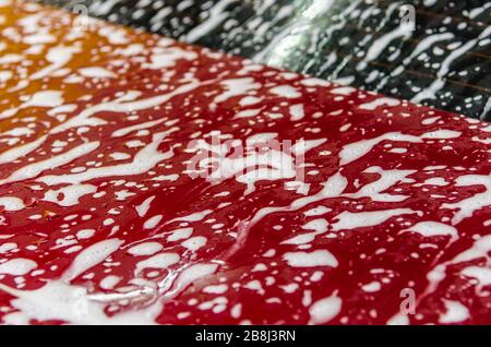 Bubbles on the red car.Car wash texture Stock Photo