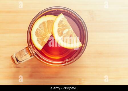 Black Tea with slices of Lemon in glass mug, top view Stock Photo