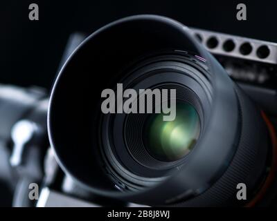 Professional digital camera on black background, lens close up, photography and creativity concept Stock Photo