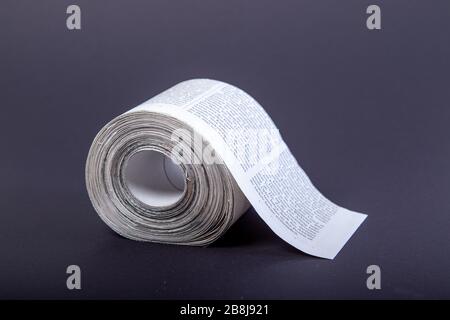 toilet paper made out of newspapers, alternative toilet paper, isolated on black, newspaper roll, close-up Stock Photo