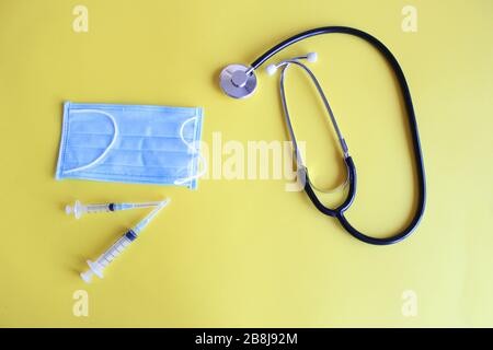 Top view black stethoscope on yellow background. For check heart or health check up concept Stock Photo