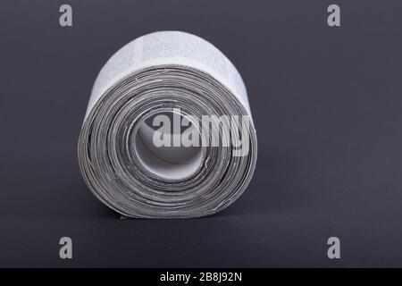 toilet paper made out of newspapers, alternative toilet paper, isolated on black, newspaper roll, close-up Stock Photo