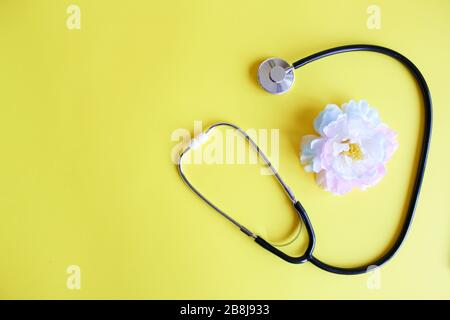 Top view black stethoscope on yellow background. For check heart or health check up concept Stock Photo