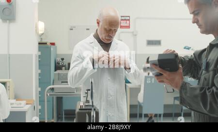 Chief scientist preparing for a video interview in the vintage style laboratory Stock Photo