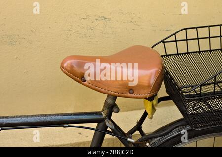 Vintage bike saddle made of brown leather (Pesaro, Italy, Europe) Stock Photo
