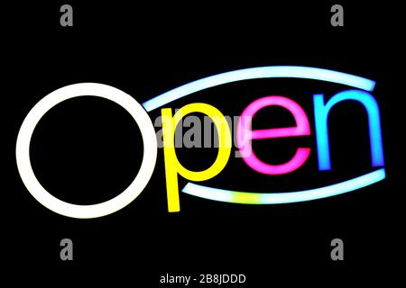 blurred text OPEN sign LED Bokeh light colorful on dark wall, Neon Light led letter Open on background black Stock Photo