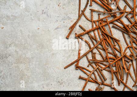 Rusty used nails on a cement metal background Stock Photo