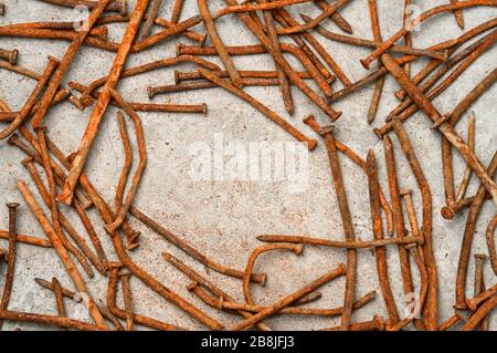 Rusty used nails on a cement metal background Stock Photo