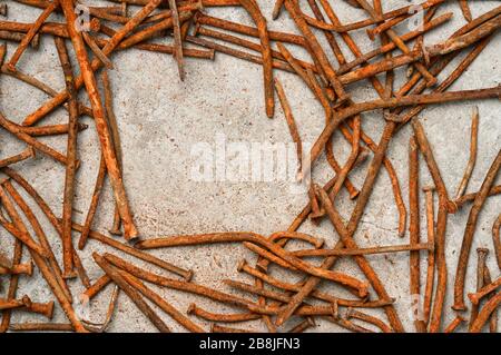 Rusty used nails on a cement metal background Stock Photo