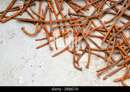 Rusty used nails on a cement metal background Stock Photo