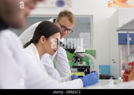 A group of scientists conducts research in a scientific laboratory using advanced technology. COVID-19. COVID Coronavirus Stock Photo