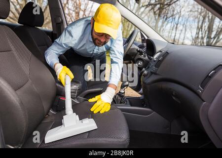 Portrait of worker use car interior steam cleaner. Vapor sterilization  Stock Photo - Alamy