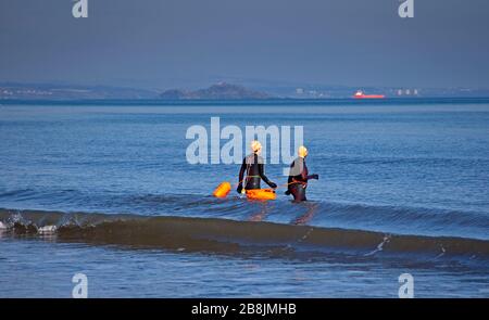 Portobello, Edinburgh, Scotland, UK. 22nd Mar, 2020. Sunshine and blue skies with an early morning temperature of 2 degrees centigrade rising to 8 degrees by noon. A variety of people out on the beach relaxing and enjoying activities to get away from the television and radio. Stock Photo