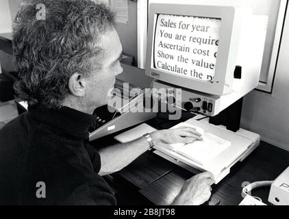 Visually impaired man using large print screen at RNIB Loughborough, UK 1990 Stock Photo