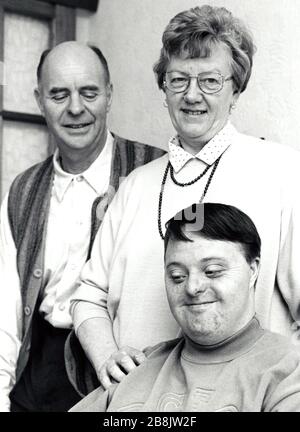 Young man with Down's Syndrome with his parents UK 1995 MR Stock Photo