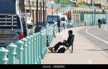 Brighton UK 22nd March 2020 - Visitors enjoy some Spring sunshine today in Brighton during the Coronavirus COVID-19 pandemic crisis . Credit: Simon Dack / Alamy Live News Stock Photo