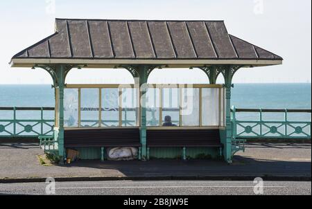 Brighton UK 22nd March 2020 - Visitors enjoy some Spring sunshine today in Brighton during the Coronavirus COVID-19 pandemic crisis . Credit: Simon Dack / Alamy Live News Stock Photo