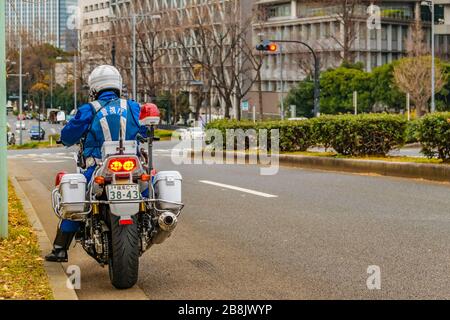 TOKYO, JAPAN, JANUARY - 2019 - Back view police traffic at motorcycle standing at avenue, chiyoda district, tokyo, japan Stock Photo