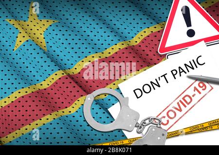Democratic Republic of the Congo flag and police handcuffs with inscription Don't panic on white paper. Coronavirus or pandemic 2019-nCov virus concep Stock Photo