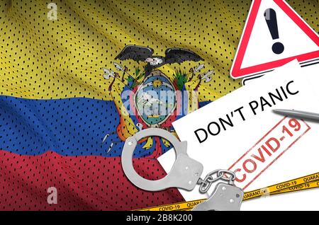 Ecuador flag and police handcuffs with inscription Don't panic on white paper. Coronavirus or pandemic 2019-nCov virus concept Stock Photo