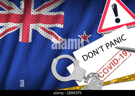 New Zealand flag and police handcuffs with inscription Don't panic on white paper. Coronavirus or pandemic 2019-nCov virus concept Stock Photo