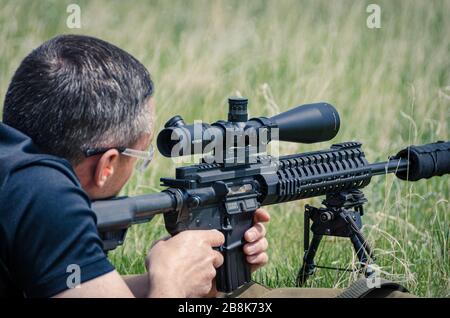 Sniper with rifle on a position Stock Photo - Alamy
