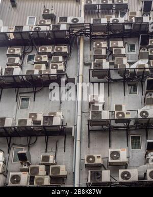 Condenser units of split system air conditioners on the outer wall of building in Kuala Lumpur Malaysia. Stock Photo