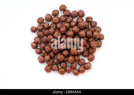 Dry breakfast - chocolate balls. Corn balls with chocolate top view. Stock Photo
