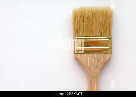 Paint brush with natural pile. Paint tools on a white background top view. Paint brush with wooden handle. Stock Photo